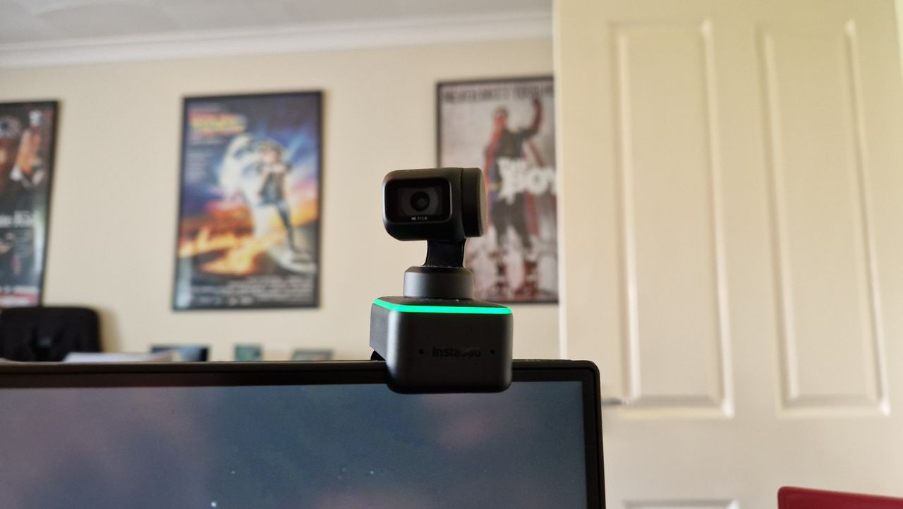 Insta360 Link on top of a monitor showing the lens