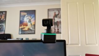 Insta360 Link on top of a monitor showing the lens