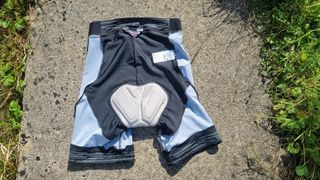 Shorts inside out laid on ground showing the back of the shorts and pad