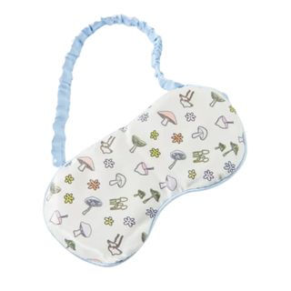 A cream and blue sleep mask with a a fungi pattern