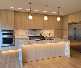 A wooden kitchen with wood floors that blend seamlessly into the cabinets