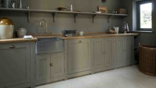 green utility room with belfast sink