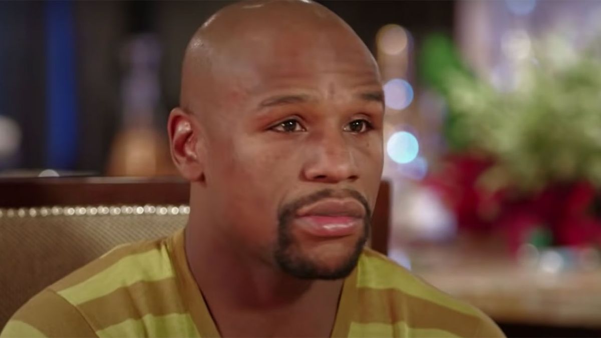 Floyd Mayweather sitting down for an interview with Showtime, dressed in a yellow and brown striped shirt.