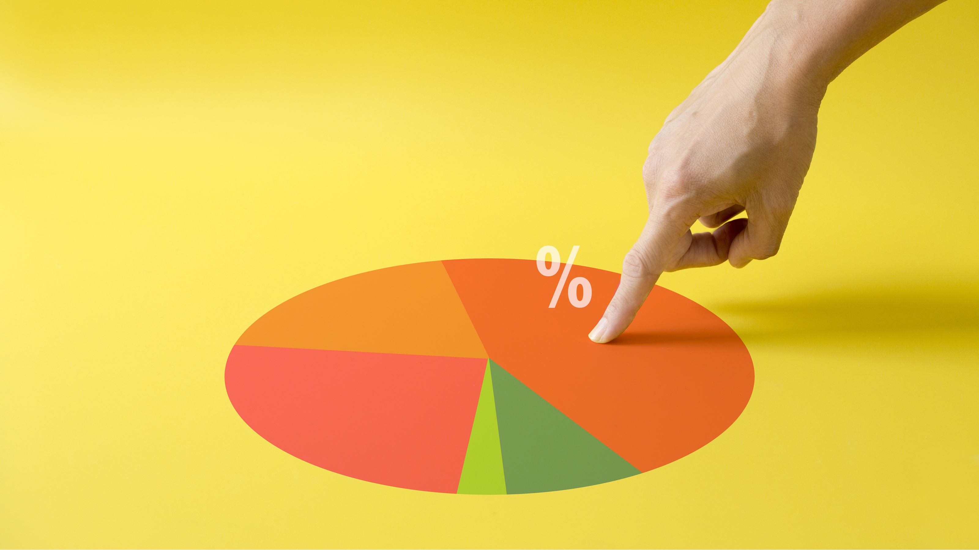 A pie chart with a finger pointing at the largest wedge.