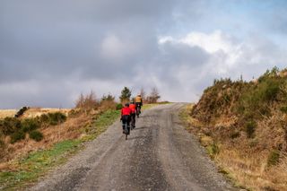 Male cyclist riding on gravel