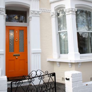 house with orange front door and number 4