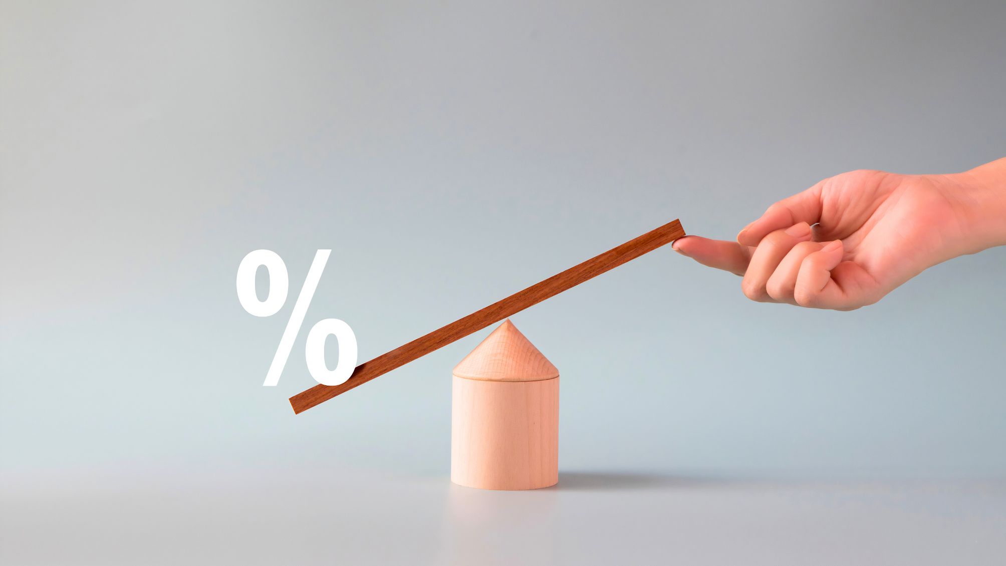 Hand lifting up one side of the balance scale