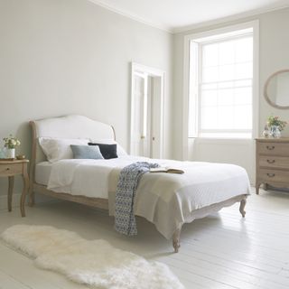bedroom with chest of drawers and side table
