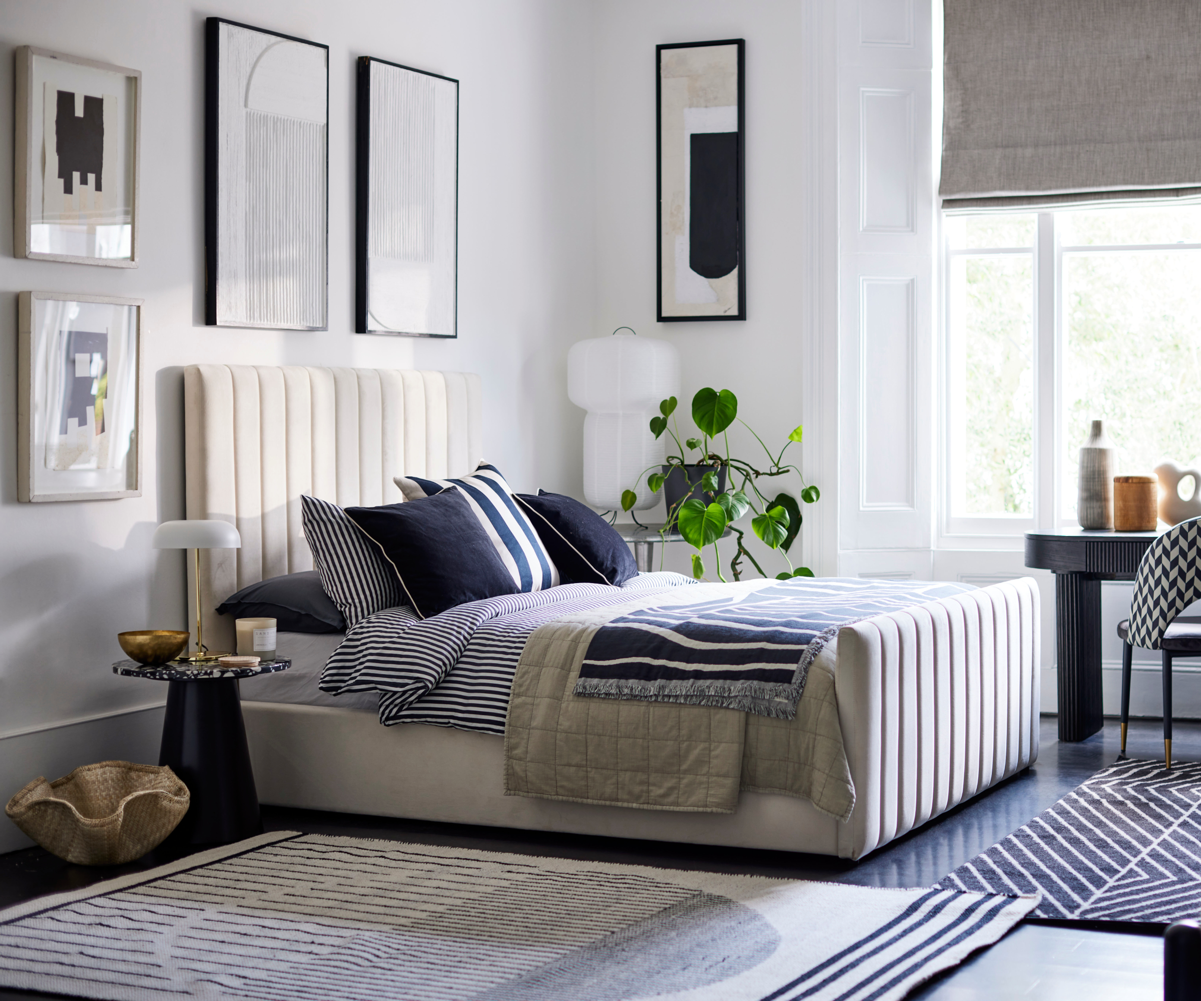 monochrome bedroom scheme with white walls and graphic wall art