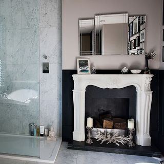 bathroom with fireplace and mirror