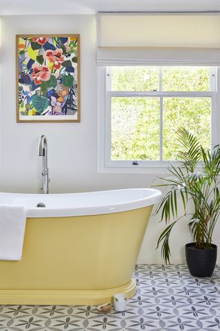 Yellow bath by BC designs in a white bathroom