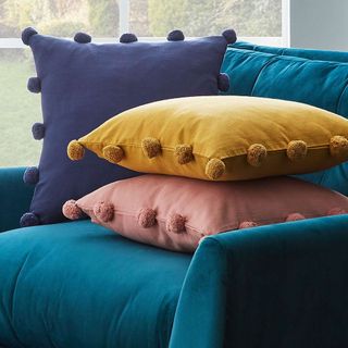 room with pom-pom cushions