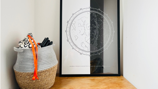 A storage basket next to a large framed picture.