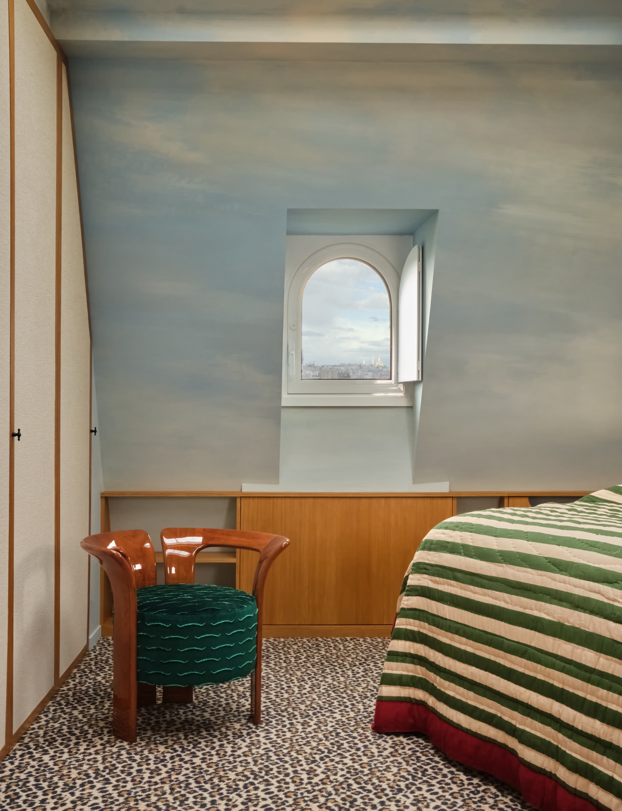 a bedroom with a painted mural of a light blue sky