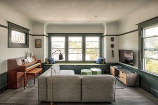 Living space seating at Alameda Renovation with grey couch and a piano