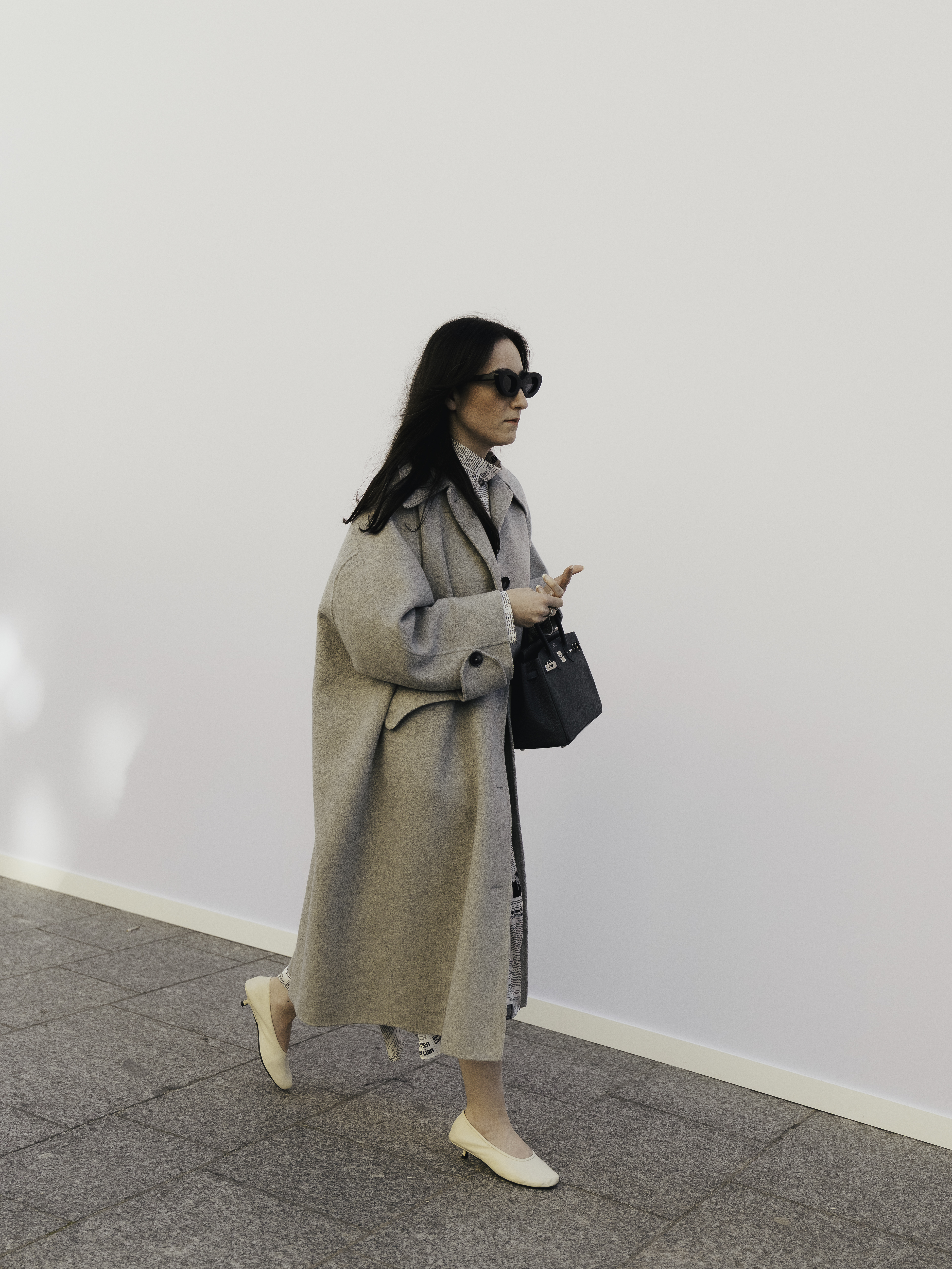 woman wearing trench coat and ballet flats