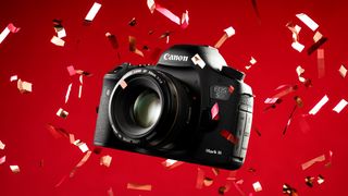 A Canon EOS 5D Mark III camera surrounded by colorful confetti against a vibrant red background, showcasing its sleek design