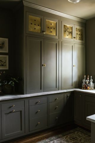 a grey kitchen with warm brass accents