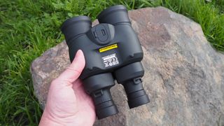Canon 12x36 IS III binoculars being held upside down