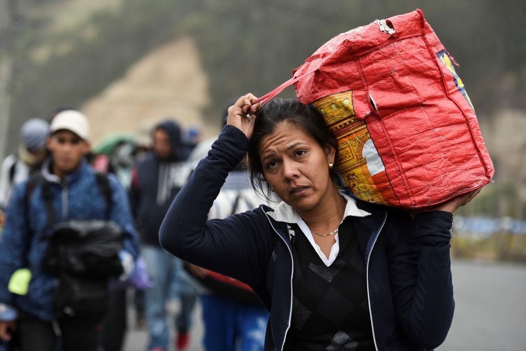 A Venezuelan migrant walks along the road.