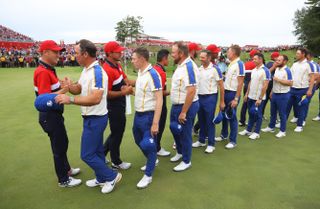 Golfers shake hands after the Ryder Cup