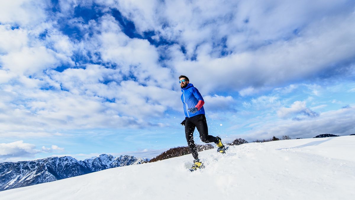 A man running in snowshoes