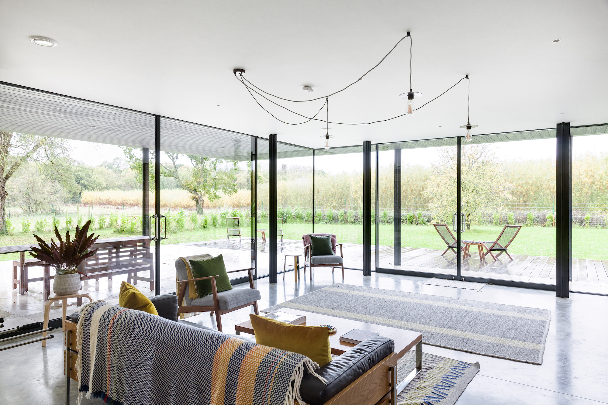 living room with concrete flooring and large sliding doors