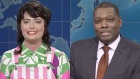 Sarah Sherman appears on Weekend Update hosted by Michael Che, who is pictured next to her, both at the Weekend Update desk.
