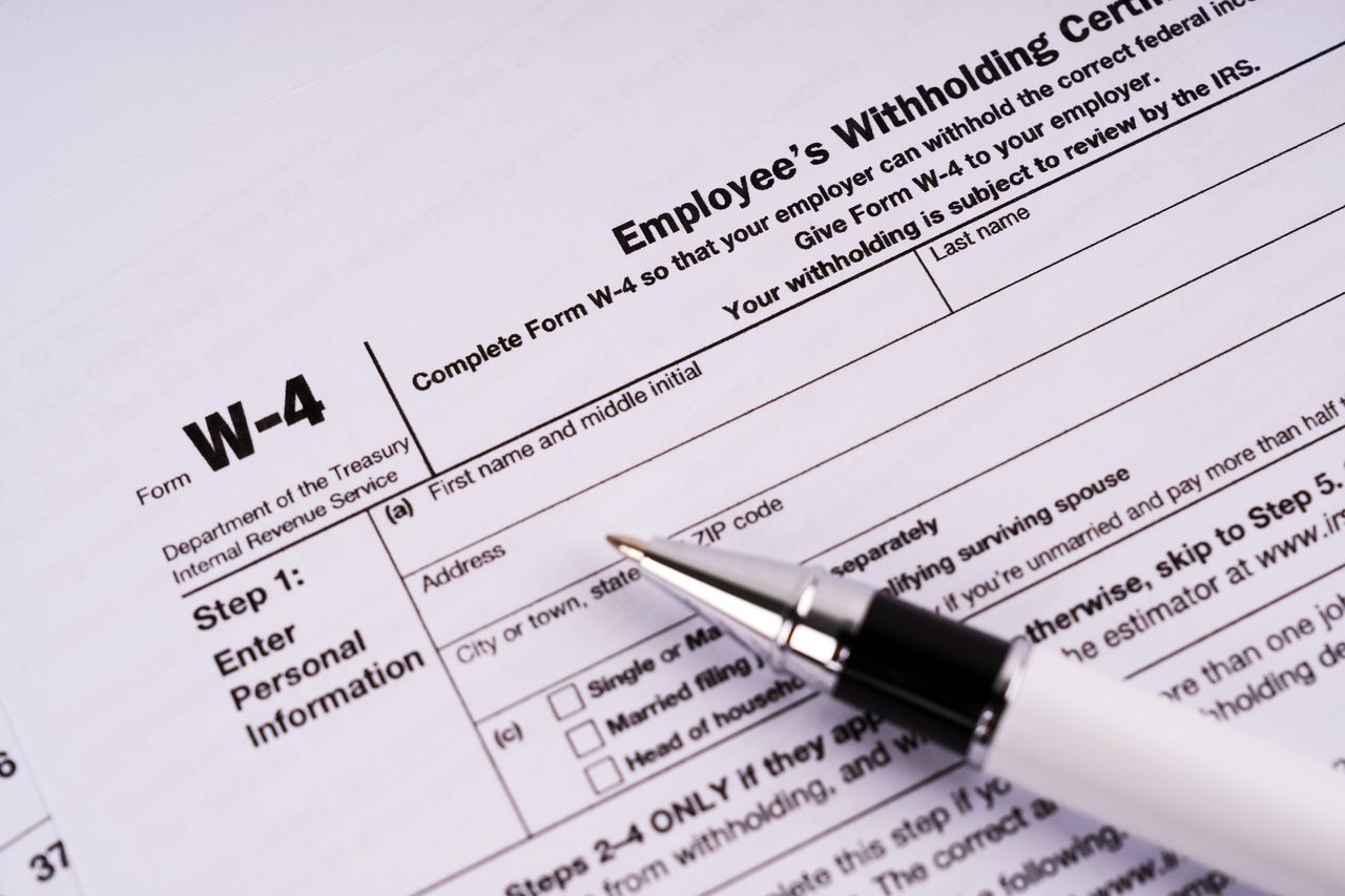 image of the IRS W-4 form with a pen on it