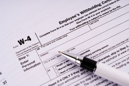 image of the IRS W-4 form with a pen on it