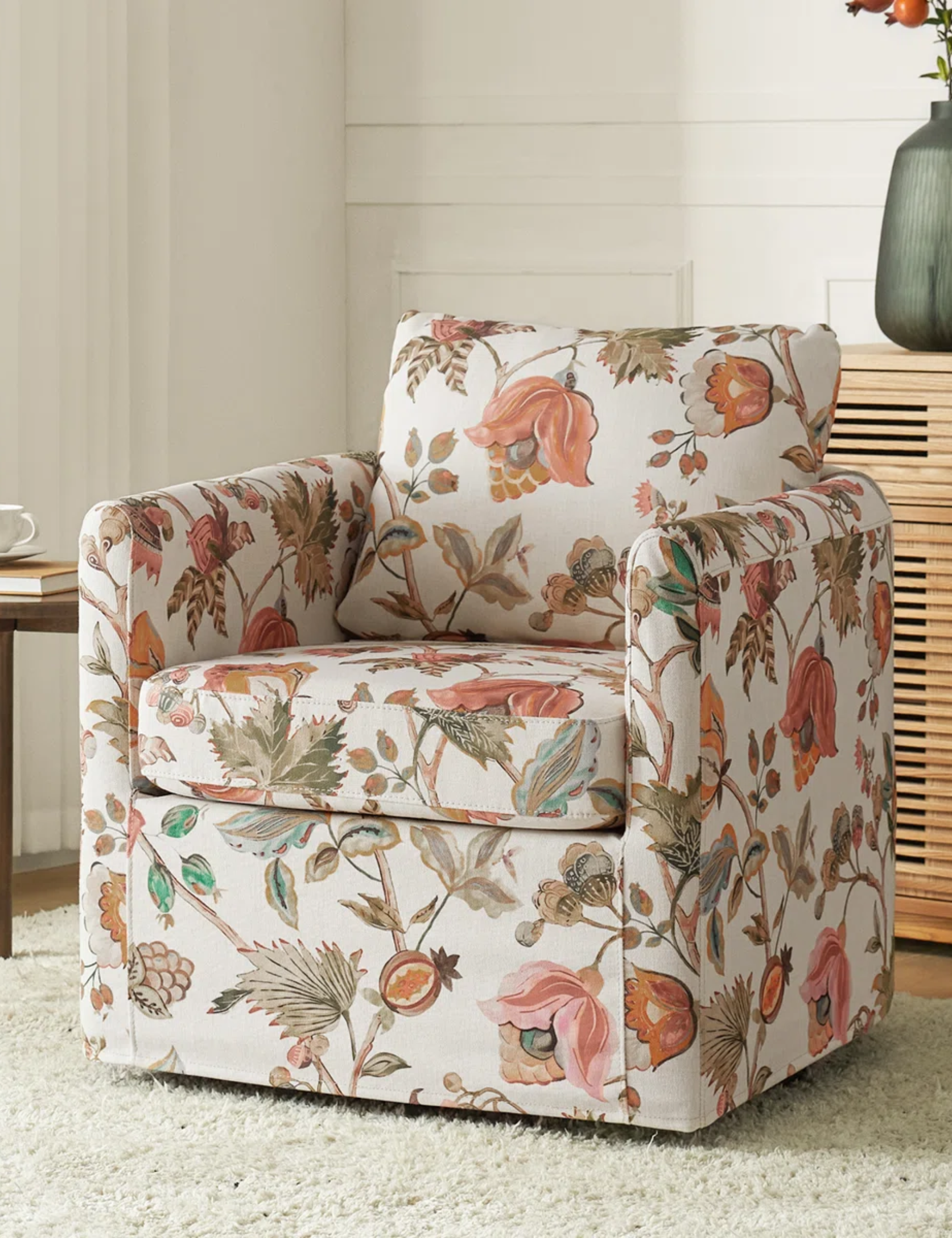 Floral slipcovered accent chair styled in a neutral living room