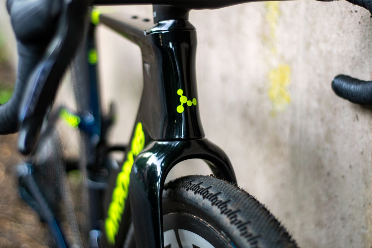 An Argon 18 Anti Matter gravel bike leaning against a concrete wall.