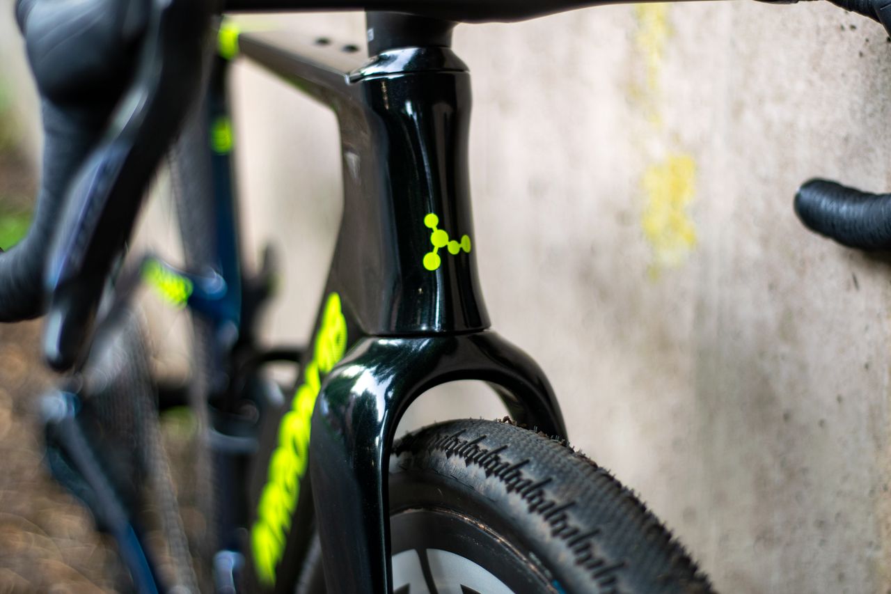 An Argon 18 Anti Matter gravel bike leaning against a concrete wall.
