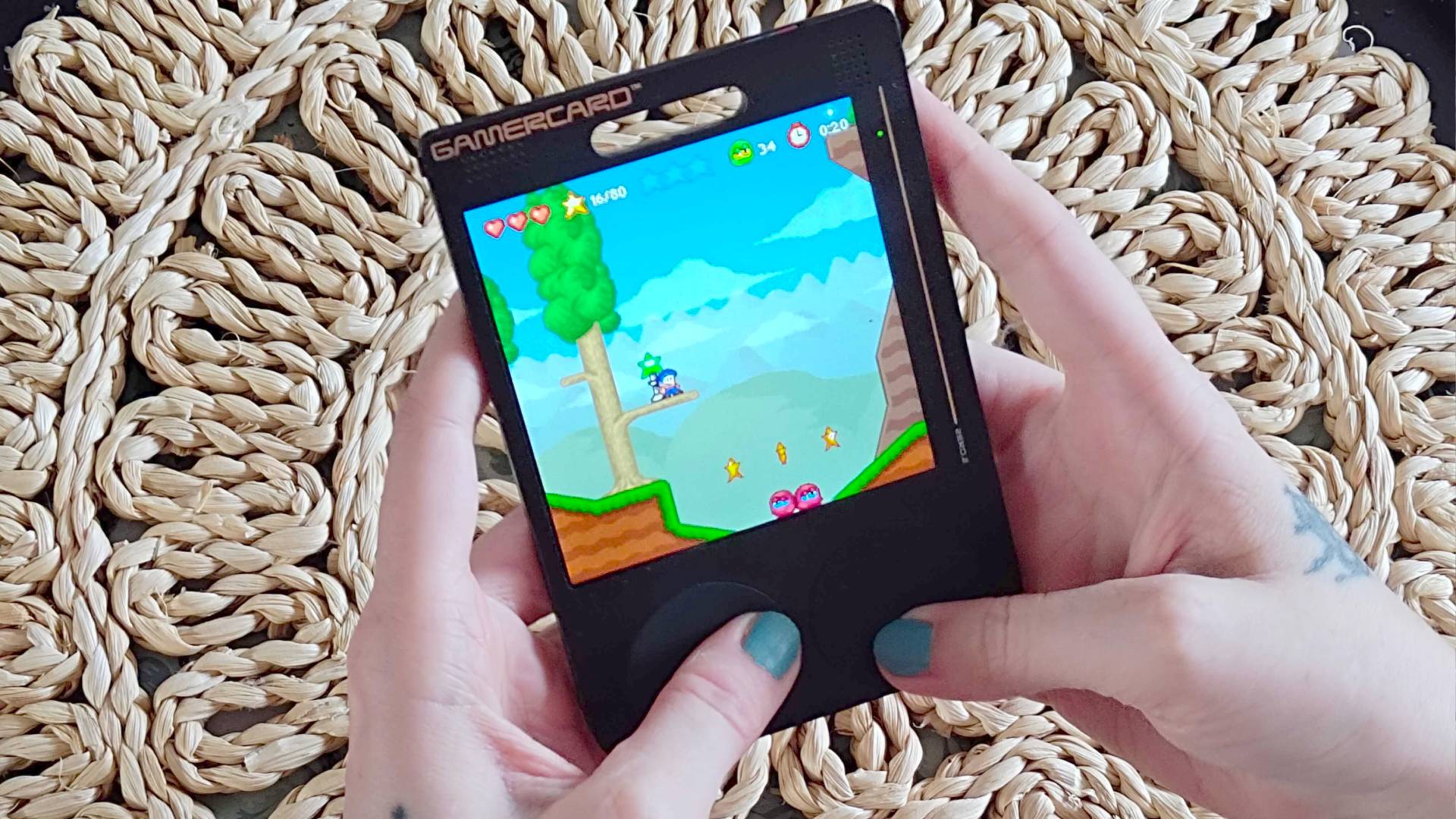 Hands using Gamercard to play Bloo Kid 2.