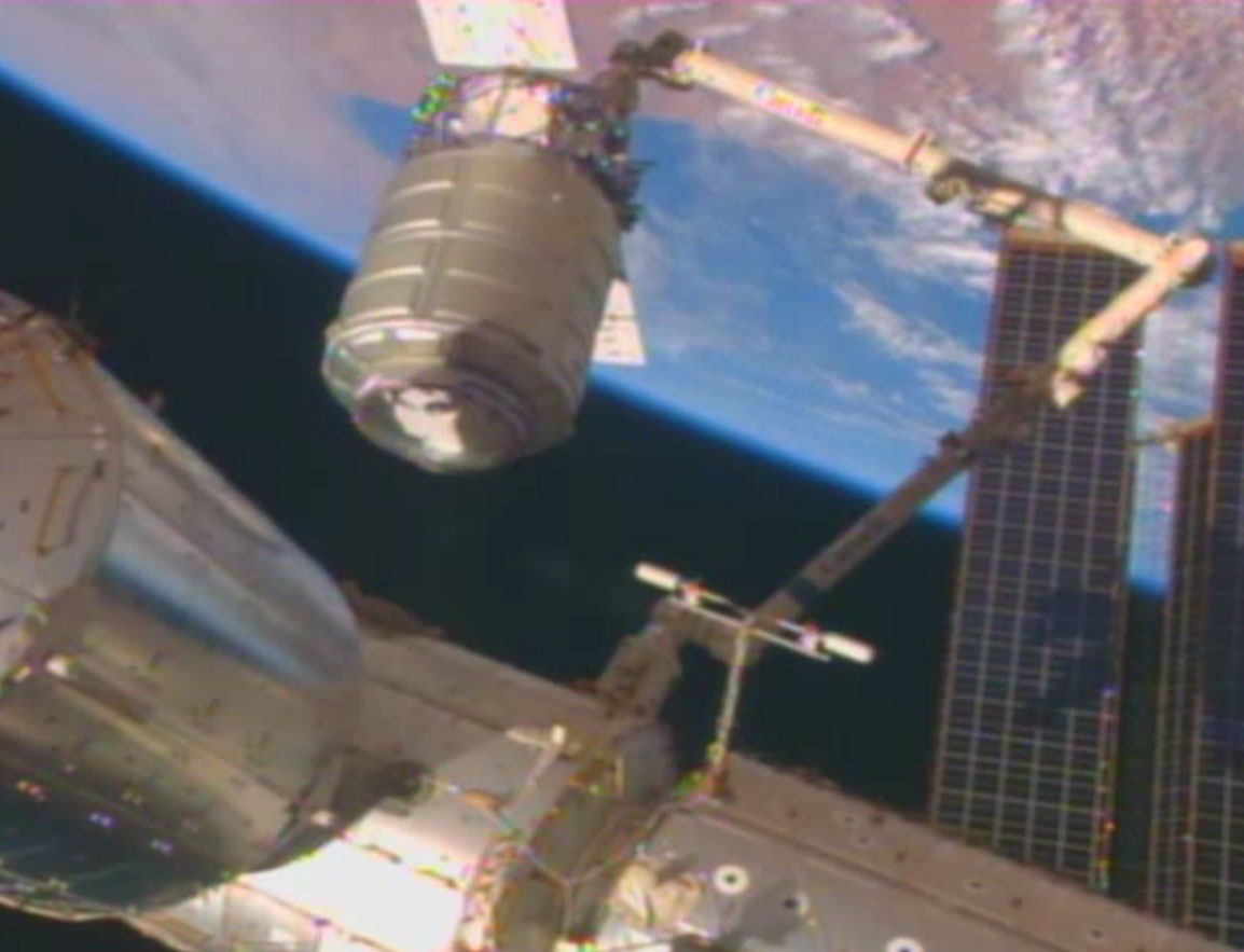 The Orb-1 Cygnus cargo ship built by Orbital Sciences Corp. of Dulles, Va., is seen at the end of a robotic arm with a dazzling view of Earth as the backdrop in this view from the International Space Station on Jan. 12, 2014.