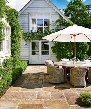 warm natural stone paving on patio with parasol