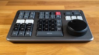 Blackmagic Davinci Resolve Speed Editor on a wooden surface