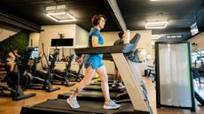 Woman walking on treadmill in gym