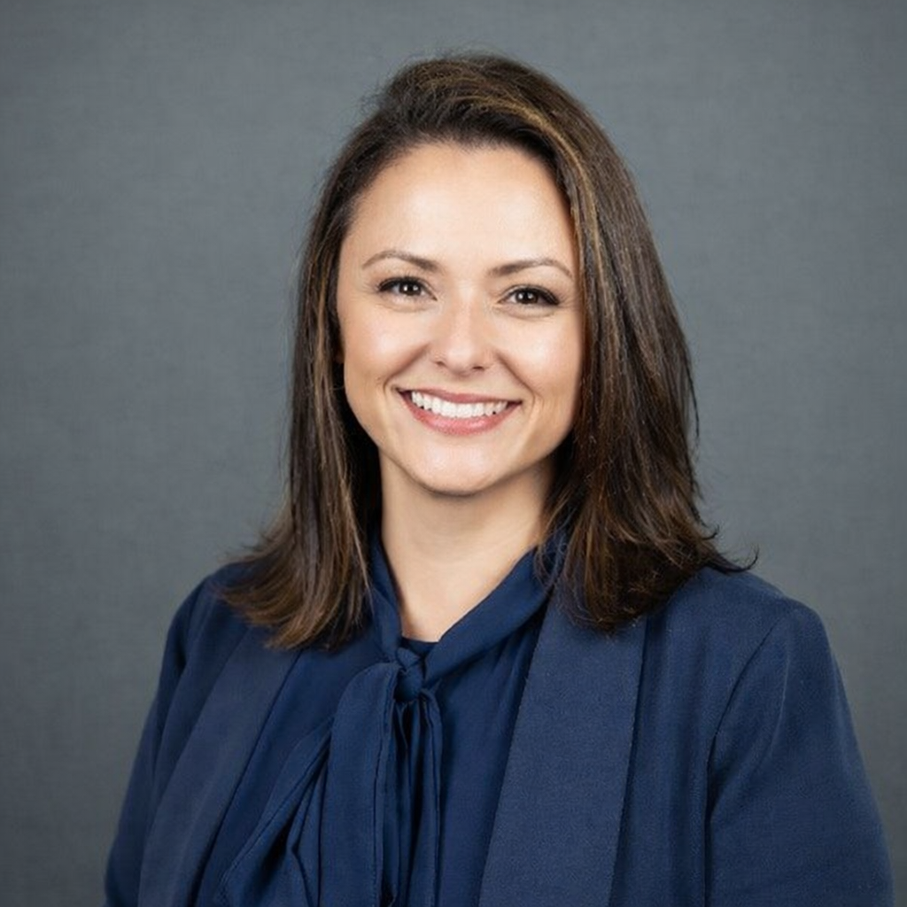 Head and shoulders of woman smiling at the camera