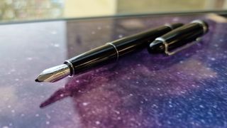 A closeup photo of the Adonit Star stylus on a screen that has a galaxy background