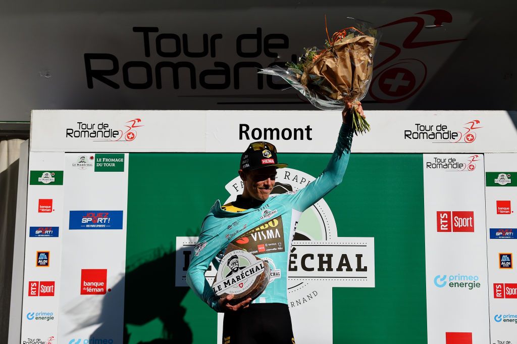 ROMONT SWITZERLAND APRIL 27 Rohan Dennis of Australia and Team Jumbo Visma celebrates winning the turquoise leader jersey on the podium ceremony after the 75th Tour De Romandie 2022 Stage 1 a 178km stage from La Grande Beroche to Romont 777m TDR2022 on April 27 2022 in Romont Switzerland Photo by Dario BelingheriGetty Images