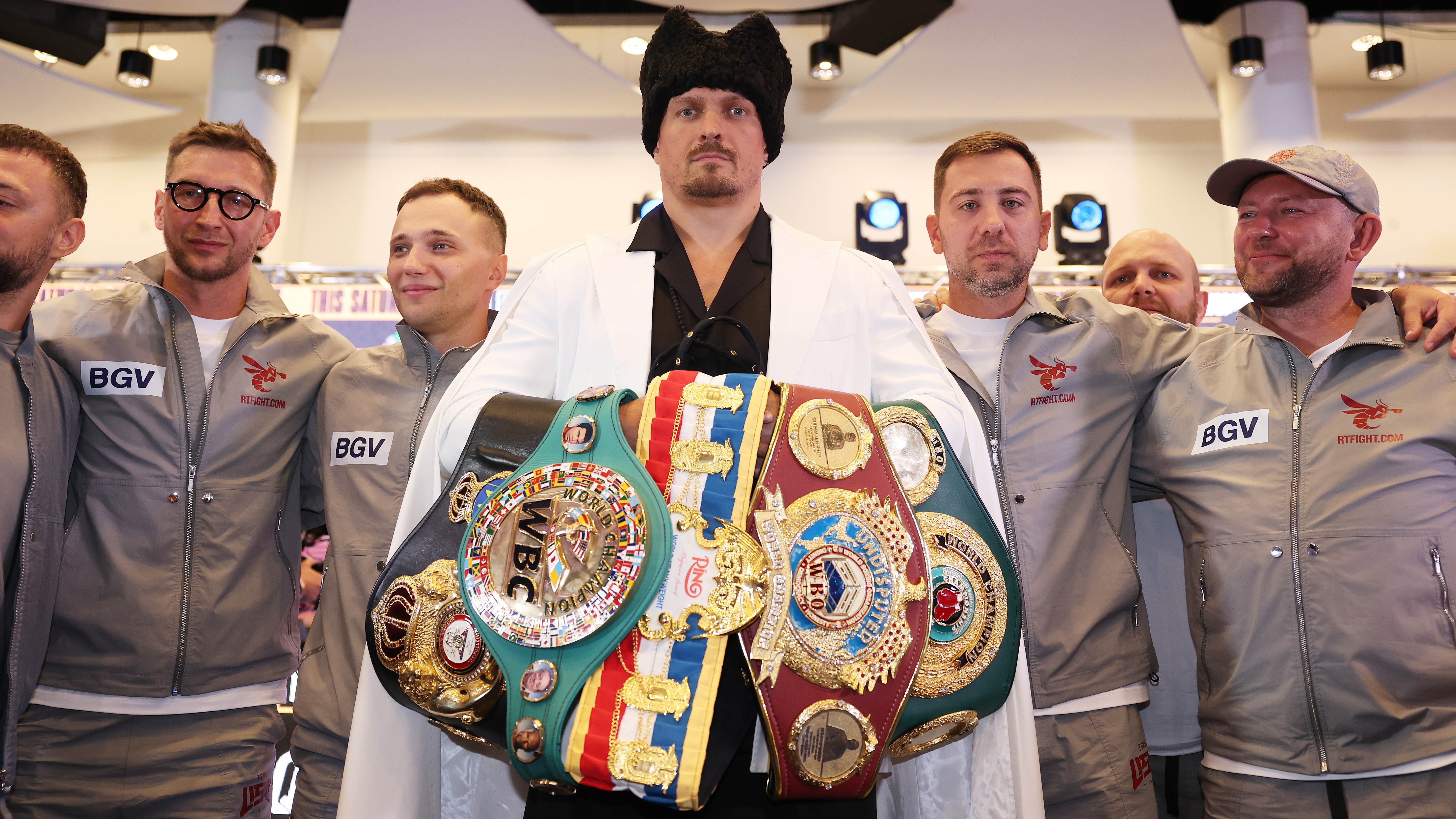 Oleksandr Usyk poses for a photo with his belts during the 'Undisputed' press conference at Wembley Stadium