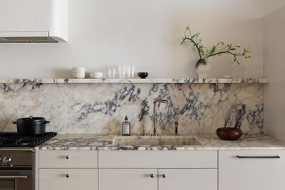 A kitchen with a marble countertop