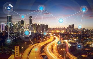 City with network of connecting symbols overlaid - depiction of a smart city