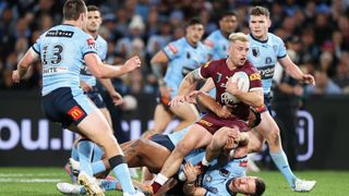 Cameron Munster of the Queensland Maroons is tackled during game one of State of Origin 2022