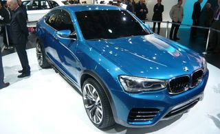 Blue BMW X4 concept car on display at a car show