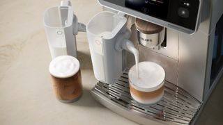 Philips Caf&eacute; Aromis coffee maker dispensing macchiato 
