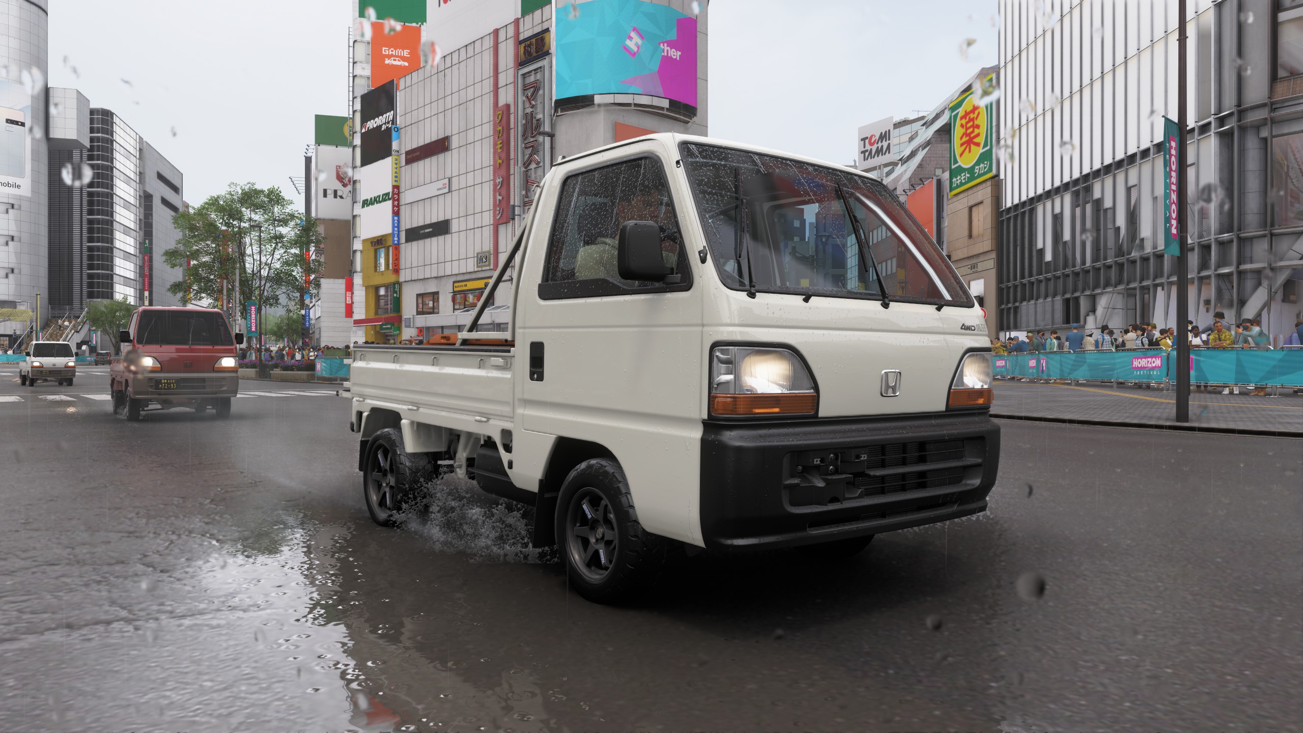 A kei truck driving through Shibuya.