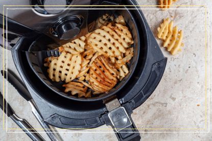 A close up of some waffle fries in an air fryer
