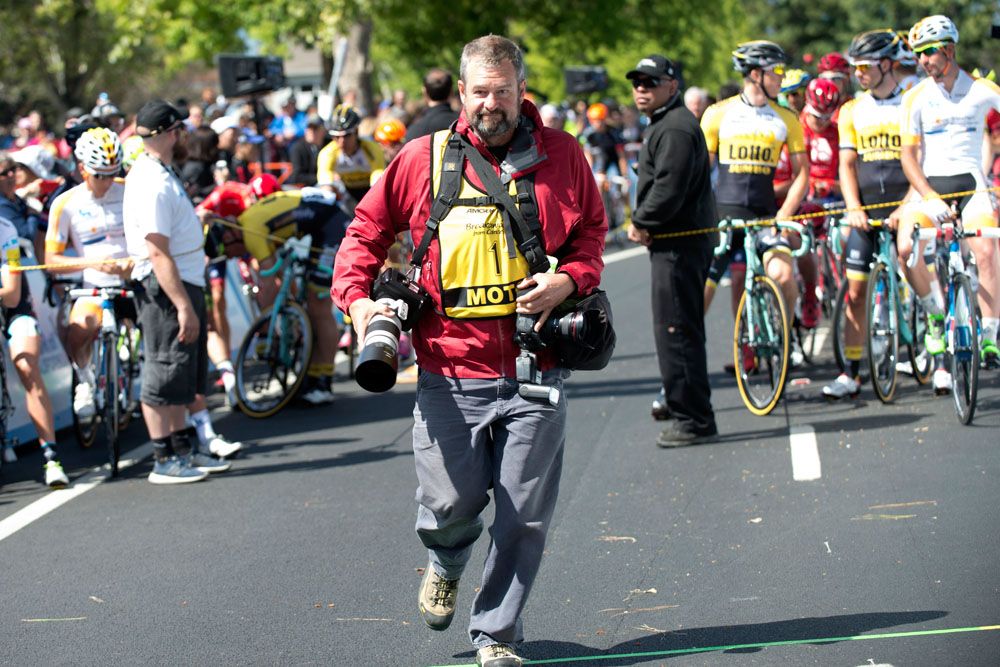 Doug Pensinger runs to get behind the photographers line at a stage start